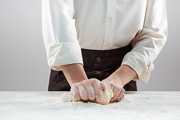 Image showing Hands kneading a dough