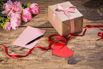 Image showing The gift box with hearts on wooden background