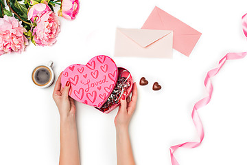 Image showing The female hands with gift box on white background