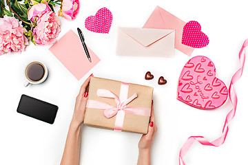 Image showing The female hands with gift box on white background