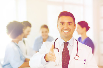 Image showing happy doctor over group of medics at hospital