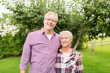 Image showing happy senior couple hugging at summer garden