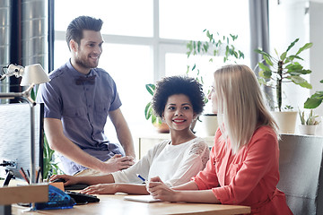 Image showing happy creative team talking in office