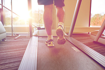 Image showing close up of man legs walking on treadmill in gym