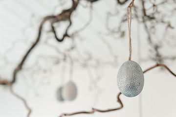 Image showing Decorative easter eggs hanging from a twig