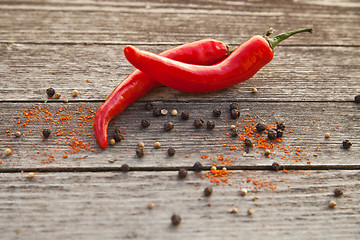 Image showing Red hot chili peppers on wood