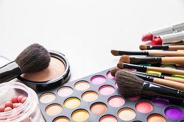 Image showing Make-up multicolored palette, brushes and cosmetics.