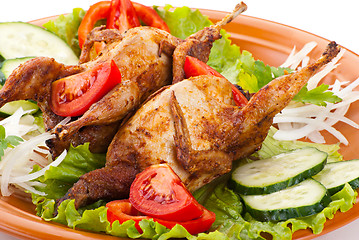 Image showing Two whole quail with cucumber, tomatoes and onion