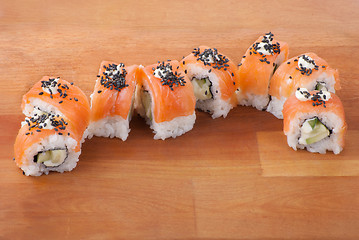 Image showing Closeup japanese sushi on wooden plate