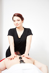 Image showing Young woman getting back massage