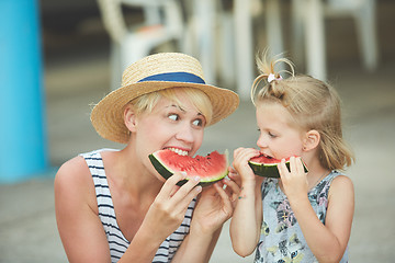 Image showing Mother And Daughter Enjoying Slices Of WaterMelon