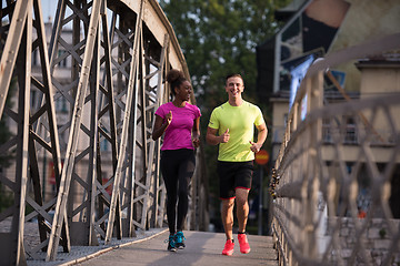 Image showing multiethnic couple jogging in the city