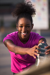 Image showing African American woman doing warming up and stretching