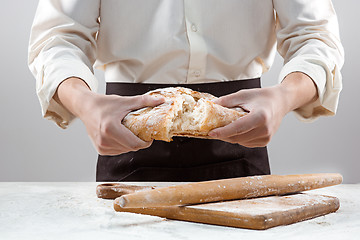 Image showing The male hands and rustic organic loaf of bread