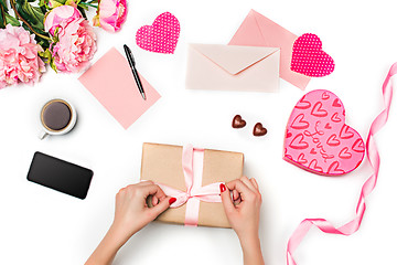 Image showing The female hands with gift box on white background