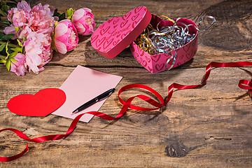 Image showing The gift box with hearts on wooden background