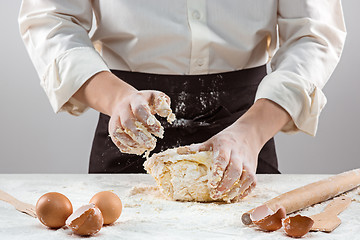 Image showing Hands kneading a dough