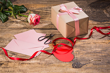 Image showing The gift box with hearts on wooden background