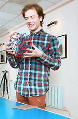 Image showing Young Man Holding The Volumetric Model Of Geometric Solid