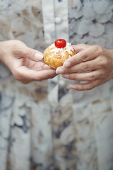 Image showing Woman holding Christmas eclair