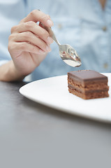 Image showing Woman eating chocolate cake