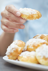 Image showing Woman eating eclairs