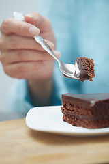 Image showing Woman eating chocolate cake