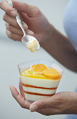 Image showing Woman eating fruit mousse