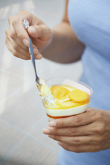 Image showing Woman eating fruit mousse