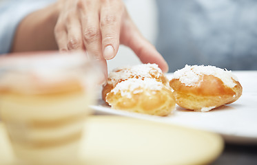 Image showing Woman taking eclairs 