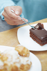 Image showing Woman eating chocolate cake