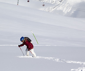 Image showing Little skier on off-piste slope with new fallen snow at sun day