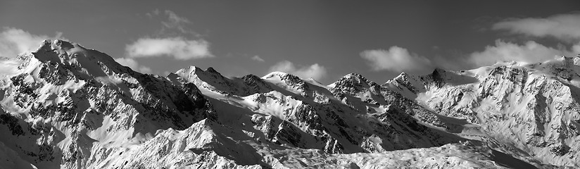 Image showing Black and white panoramic view on snowy mountains in sunny day