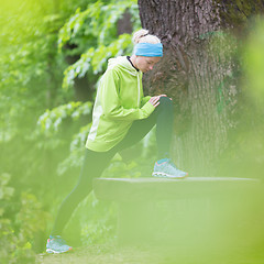 Image showing Sporty woman  working out in forest. 