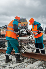 Image showing Railway workers repairing rail