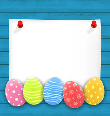 Image showing Celebration empty paper card with Easter ornamental eggs on wood
