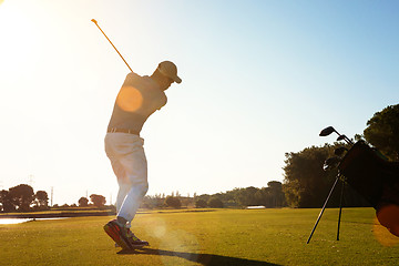 Image showing golf player hitting shot with club