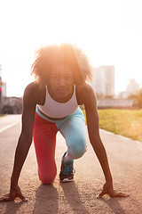 Image showing Portrait of sporty young african american woman running outdoors