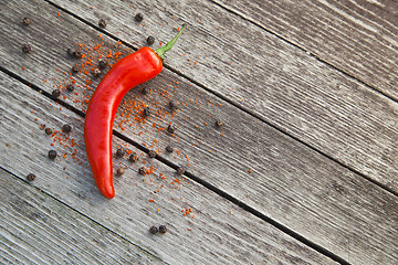 Image showing Red hot chili peppers on wood