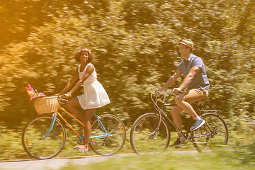 Image showing Young multiethnic couple having a bike ride in nature