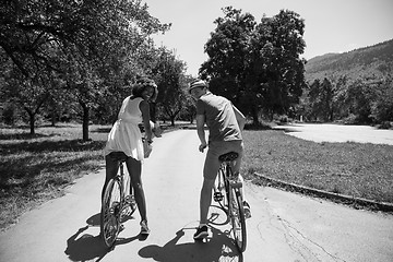 Image showing Young multiethnic couple having a bike ride in nature