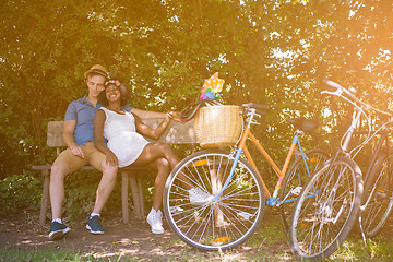 Image showing Young multiethnic couple having a bike ride in nature