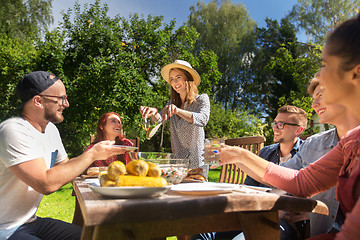 Image showing happy friends having dinner at summer garden party