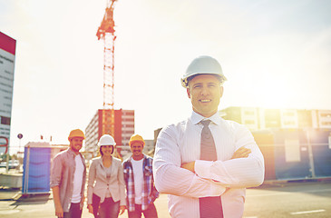 Image showing happy builders and architect at construction site