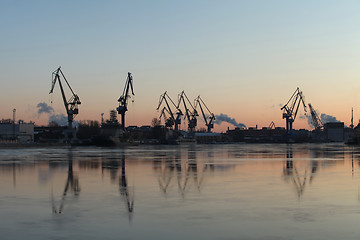 Image showing  Silhouettes of of portal cranes on the horizon