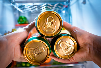 Image showing Man taking beer from a fridge