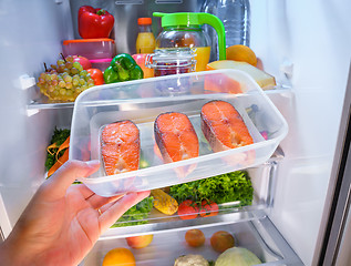 Image showing Raw Salmon steak in the open refrigerator