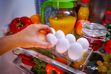 Image showing Chicken eggs on a shelf open refrigerator