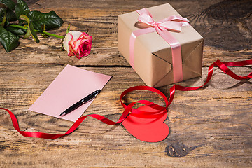 Image showing The gift box with hearts on wooden background