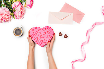 Image showing The female hands with gift box on white background